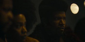 Movie still from “They Cloned Tyrone” (2023), directed by Juel Taylor – A man and a woman in a dark room; Close Up shot, Low angle