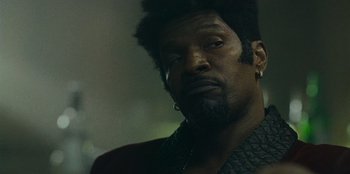 Movie still from “They Cloned Tyrone” (2023), directed by Juel Taylor – A person with a beard; Close Up shot, Low angle