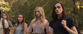 Movie still from “They/Them” (2022), directed by John Logan – A group of people standing next to each other in a park; Medium shot, Low angle
