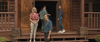 Movie still from “They/Them” (2022), directed by John Logan – A man and a woman standing next to two other people; Wide shot, Low angle