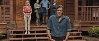 Movie still from “They/Them” (2022), directed by John Logan – A group of people standing on a wooden deck; Medium shot, Over the shoulder angle