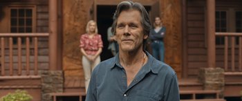 Movie still from “They/Them” (2022), directed by John Logan – A person wearing a blue shirt; Close Up shot, Over the shoulder angle