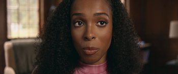 Movie still from “They/Them” (2022), directed by John Logan – A person wearing a pink shirt; Close Up shot, Over the shoulder angle