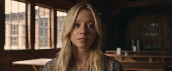 Movie still from “They/Them” (2022), directed by John Logan – A young woman with long blonde hair and a necklace; Close Up shot, Low angle