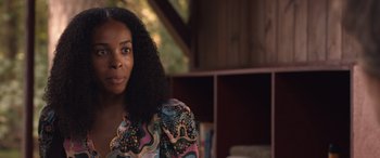 Movie still from “They/Them” (2022), directed by John Logan – A person wearing a colorful shirt; Close Up shot, Over the shoulder angle