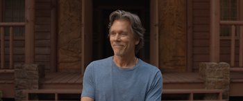 Movie still from “They/Them” (2022), directed by John Logan – A person wearing a blue t - shirt; Close Up shot, Low angle