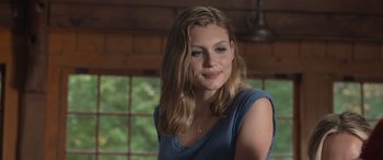Movie still from “They/Them” (2022), directed by John Logan – A beautiful young lady wearing a blue shirt; Close Up shot, Over the shoulder angle