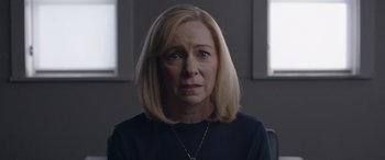 Movie still from “They/Them” (2022), directed by John Logan – A woman with blonde hair wearing a black shirt; Close Up shot, Over the shoulder angle