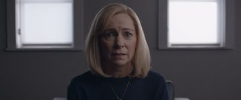 Movie still from “They/Them” (2022), directed by John Logan – A woman with blonde hair wearing a black shirt; Close Up shot, Over the shoulder angle