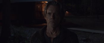 Movie still from “They/Them” (2022), directed by John Logan – A person wearing a shirt; Close Up shot, Over the shoulder angle