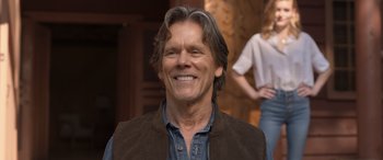 Movie still from “They/Them” (2022), directed by John Logan – A person wearing a vest; Close Up shot, Over the shoulder angle