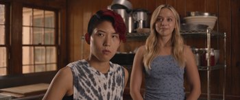 Movie still from “They/Them” (2022), directed by John Logan – Two people standing in a kitchen next to each other; Close Up shot, Over the shoulder angle