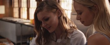 Movie still from “They/Them” (2022), directed by John Logan – A person wearing an apron; Close Up shot, Over the shoulder angle