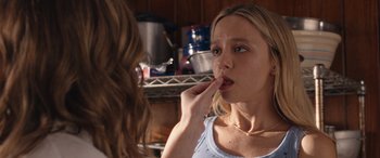 Movie still from “They/Them” (2022), directed by John Logan – A woman is putting a tooth brush in her mouth in front of a mirror; Close Up shot, Over the shoulder angle