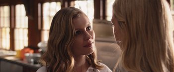 Movie still from “They/Them” (2022), directed by John Logan – A woman sitting next to another woman in a car; Close Up shot, Over the shoulder angle