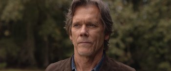 Movie still from “They/Them” (2022), directed by John Logan – A person wearing a jacket; Close Up shot, Low angle