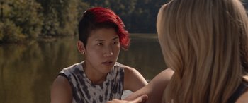 Movie still from “They/Them” (2022), directed by John Logan – A woman with red hair sitting next to another woman; Close Up shot, Over the shoulder angle