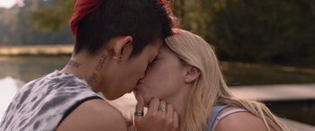 Movie still from “They/Them” (2022), directed by John Logan – A man and a woman kissing each other on the cheek; Close Up shot, Over the shoulder angle