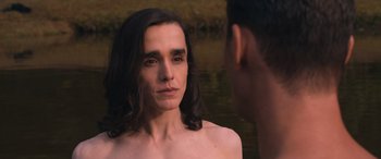 Movie still from “They/Them” (2022), directed by John Logan – A man and a woman standing next to a body of water; Close Up shot, Over the shoulder angle