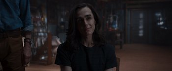 Movie still from “They/Them” (2022), directed by John Logan – A person with long hair sitting in a room; Close Up shot, Over the shoulder angle