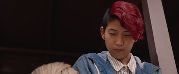 Movie still from “They/Them” (2022), directed by John Logan – A person with red hair and a striped shirt; Close Up shot, Over the shoulder angle