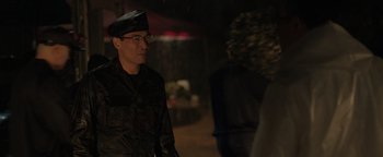 Movie still from “Thirteen Lives” (2022), directed by Ron Howard – A man in a military uniform standing next to a woman; Medium shot, Over the shoulder angle