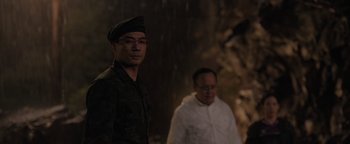 Movie still from “Thirteen Lives” (2022), directed by Ron Howard – A man in a military uniform standing next to another man; Medium shot, Over the shoulder angle
