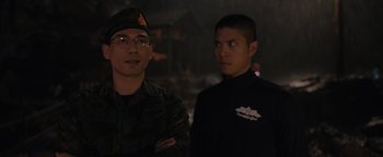 Movie still from “Thirteen Lives” (2022), directed by Ron Howard – Two young men standing next to each other in a dark room; Close Up shot, Over the shoulder angle