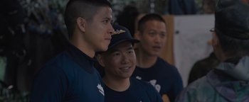 Movie still from “Thirteen Lives” (2022), directed by Ron Howard – A group of young men standing next to each other; Medium shot, Over the shoulder angle