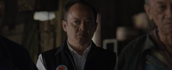 Movie still from “Thirteen Lives” (2022), directed by Ron Howard – A person wearing a jacket; Close Up shot, Over the shoulder angle