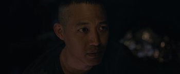 Movie still from “Thirteen Lives” (2022), directed by Ron Howard – A person looking at the camera; Close Up shot, Over the shoulder angle