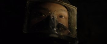 Movie still from “Thirteen Lives” (2022), directed by Ron Howard – A man in a helmet looking into the camera; Extreme Close Up shot, Low angle
