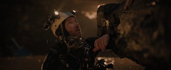 Movie still from “Thirteen Lives” (2022), directed by Ron Howard – A man on a motorcycle wearing a helmet; Close Up shot, Overhead angle