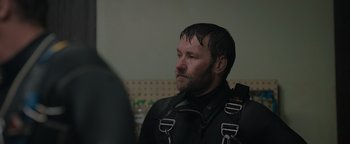 Movie still from “Thirteen Lives” (2022), directed by Ron Howard – A man in a scuba diving suit looking to his left; Close Up shot, Over the shoulder angle