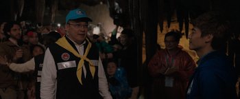 Movie still from “Thirteen Lives” (2022), directed by Ron Howard – A group of people standing in a room; Medium shot, Over the shoulder angle