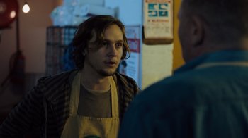 Movie still from “Escape Room” (2019), directed by Adam Robitel – A man in an apron talking to another man in an apron; Medium shot, Over the shoulder angle