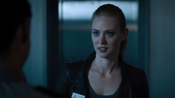 Movie still from “Escape Room” (2019), directed by Adam Robitel – A beautiful young woman with blonde hair wearing a black jacket; Close Up shot, Over the shoulder angle