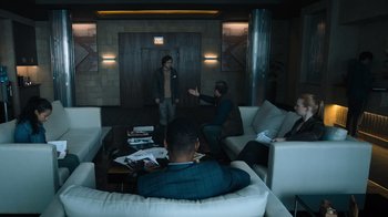 Movie still from “Escape Room” (2019), directed by Adam Robitel – A group of people sitting in a room talking to each other; Wide shot, Over the shoulder angle