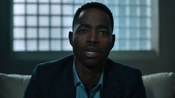 Movie still from “Escape Room” (2019), directed by Adam Robitel – A person wearing a suit and tie; Close Up shot, Over the shoulder angle