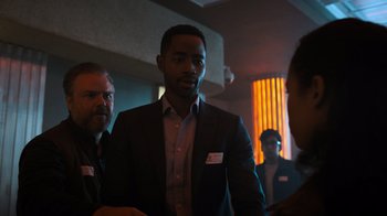 Movie still from “Escape Room” (2019), directed by Adam Robitel – A group of people standing around a room; Medium shot, Over the shoulder angle