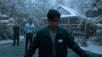 Movie still from “Escape Room” (2019), directed by Adam Robitel – A man standing next to another man on a snowy day; Medium shot, Over the shoulder angle