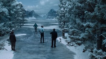Movie still from “Escape Room” (2019), directed by Adam Robitel – A group of people standing next to a body of water; Extreme Wide shot, High angle