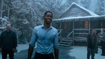 Movie still from “Escape Room” (2019), directed by Adam Robitel – A man standing in front of a log cabin in the snow; Medium shot, Over the shoulder angle