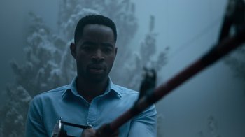 Movie still from “Escape Room” (2019), directed by Adam Robitel – A man holding a pair of scissors in his hands; Close Up shot, Over the shoulder angle