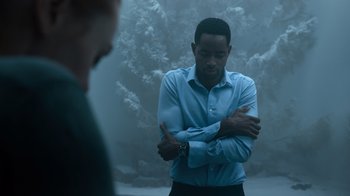 Movie still from “Escape Room” (2019), directed by Adam Robitel – A man in a blue dress shirt and black slacks; Medium shot, Over the shoulder angle