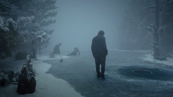 Movie still from “Escape Room” (2019), directed by Adam Robitel – A man standing on top of an ice covered lake; Extreme Wide shot, High angle