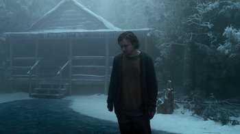 Movie still from “Escape Room” (2019), directed by Adam Robitel – A man standing in the middle of a snow covered yard; Medium shot, Low angle