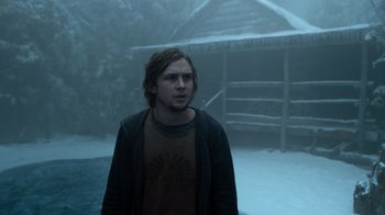 Movie still from “Escape Room” (2019), directed by Adam Robitel – A man standing in the middle of a snow covered yard; Medium shot, Low angle