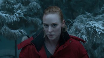 Movie still from “Escape Room” (2019), directed by Adam Robitel – A woman in a red jacket standing in front of a tree; Close Up shot, Over the shoulder angle