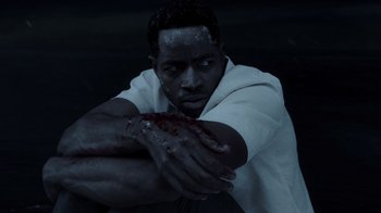 Movie still from “Escape Room” (2019), directed by Adam Robitel – A man with blood all over his face and hands; Close Up shot, High angle